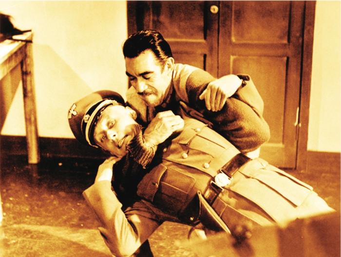 آنتونی کوئین در صحنه فیلم سینمایی توپ های ناوارون