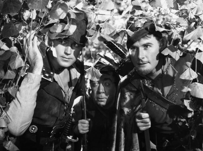 Herbert Mundin در صحنه فیلم سینمایی ماجراهای رابین هود به همراه Errol Flynn و Patric Knowles